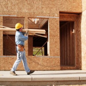 contractor carrying wood for new home before home inspection